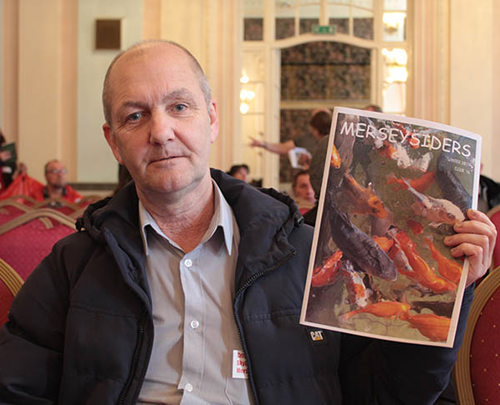 Member holding the latest newsletter - Merseysiders