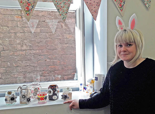 Sarah shows off candle holders from Easter crafts class