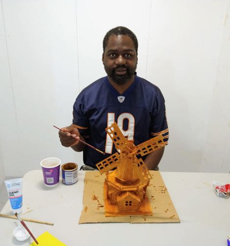 Gilbert varnishing the windmill