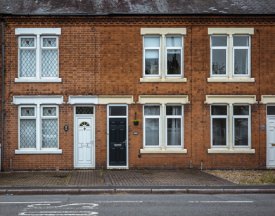 A photo of a row of terraced houses taken from the opposite side of the street.